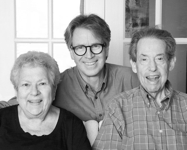 Joyce Bernhardt Siegel, Paul Tukey and Alan Siegel, seated together and smiling